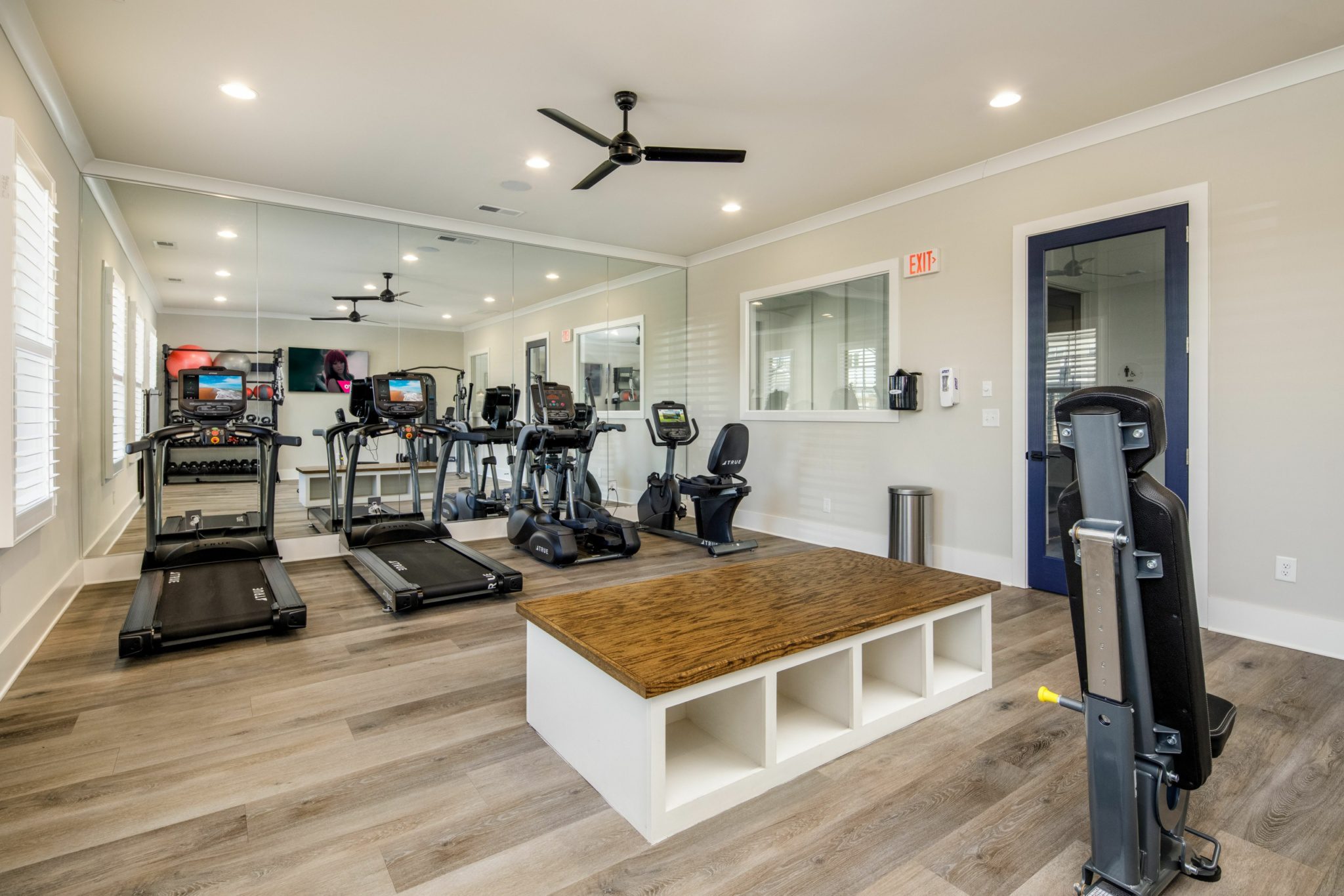 Gym room with treadmills, tvs, and other equipment